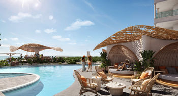 The renovated Palms Turks and Caicos features a reimagined pool deck with an oceanfront infinity pool, a chic swim-up bar and cozy day beds illuminated by rattan lanterns.