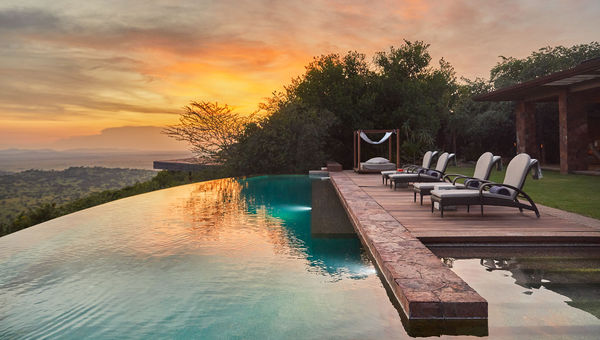 The infinity pool at Singita Kilima offers panoramic views over the Serengeti plains and wildlife migration routes. The infinity pool at Singita Kilima offers panoramic views over the Serengeti plains and wildlife migration routes.