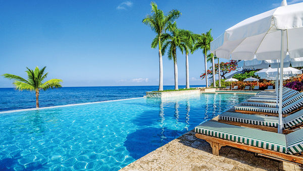The Round Hill Hotel and Villas infinity pool overlooks the resort's private beach. The Round Hill Hotel and Villas infinity pool overlooks the resort's private beach.